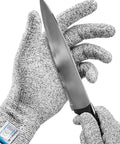 Ultra Safe Cut Resistant Gloves Level 5 Protection For Kitchen Prep Meat Handling Filleting Shucking Slicing Carving Large XL Size Heavy Duty Food Prep Hand Guard being used with a knife.