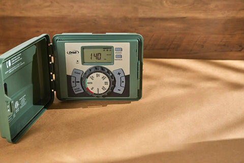 Four Station Outdoor Sprinkler Timer with Swing Panel for Lawn Care showing display and controls