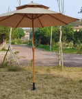 Heavy Duty Patio Umbrella Stand For 1.2 To 2.2 Inch Poles With Ground Spike Easy Carry Table Base in garden setting