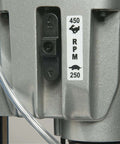 Hougen HMD905 magnetic drill, close-up of gray metal housing with 450 RPM sticker and Made in USA label.