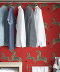 Red Zebra Safari Peel And Stick Wallpaper With Removable Self Adhesive Wall Covering for bedrooms behind hanging shirts.