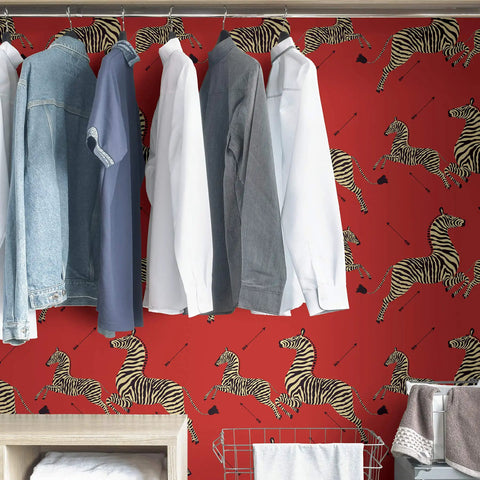 Red Zebra Safari Peel And Stick Wallpaper With Removable Self Adhesive Wall Covering for bedrooms behind hanging shirts.