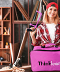Woman in workshop holding a pink saw and pink carrying case from the Pink 205-Piece Tool Kit For Gals With USB Electric Screwdriver And Drill Adapter.