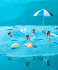 Big Time Favorite Mini Glass Jars With Cork Stoppers, 50 Pack Super Cute Wishing Bottles In 10 Unique Styles arranged on blue sand.