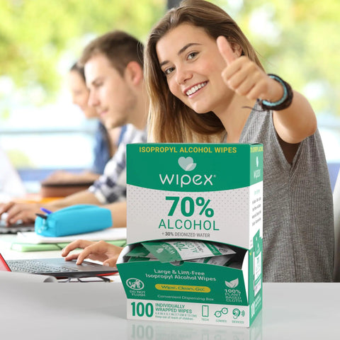 Woman using 70 Percent Isopropyl Alcohol Wipes Individually Wrapped Sachets For Electronics And Tech Gear Dispensing Box 100 Count Pack
