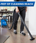 Person using Heavy Duty 8 Gallon Wet Dry Shop Vac Delivering 75 Cfm with 17-foot hose on hardwood floor.