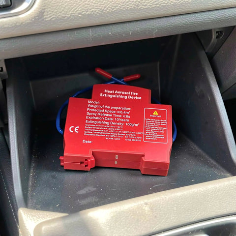 Automatic Vehicle Fire Extinguisher Set For Cars Trucks And Rvs Featuring Smart Temperature Activation heavy duty red aerosol device inside vehicle storage.