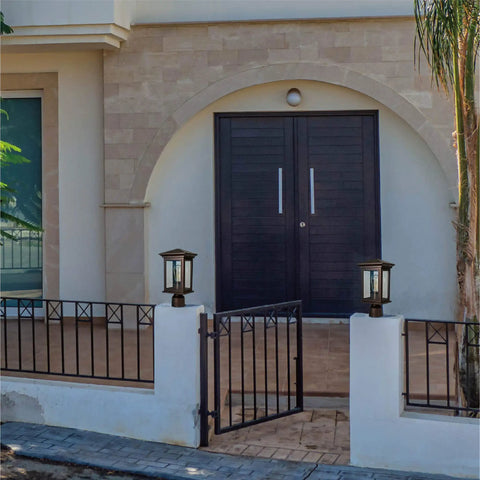 Outdoor post light built to last weatherproof lantern with oil rubbed bronze finish and tempered seeded glass on a patio.