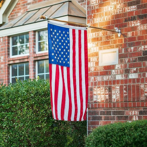 Heavy Duty 4x6 Outdoor Nylon US Flag With Embroidered Stars Sewn Stripes Brass Grommets Fade Resistant Weatherproof 420D Construction Built To Last Outdoor Use hanging on a brick wall