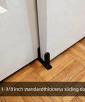 Universal Black Sliding Door Bottom Guides Set installed on 1-3/8 inch sliding doors on wooden floor