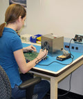 Person using Portable Solder Smoke Fume Extractor For Soldering, Jewelry Making, And Crafting, ESD Safe Base on a workbench