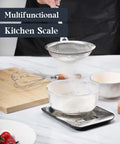 All In One 11 Pound Digital Kitchen Scale With Six Unit Modes in use for baking, compact stainless steel design on a kitchen counter