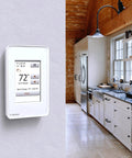 Ntrust Non Programmable Thermostat With Floor Sensor And Class A GFCI, large easy read display mounted in a rustic kitchen.