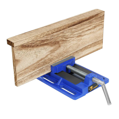 6 Inch Drill Press Vise With Slotted Base, Portable Bench Vise for Light Duty Work, holding a piece of wood, serrated jaw visible.