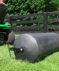 Tow Behind Poly Lawn Roller With Easy Turn Plug For Quick Fill And Dump 485 Lb Capacity being used with a riding mower