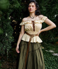 Badass Medieval Leather Belt For Renaissance Cosplay And Hella Cool Pirate Viking Props Featuring Embossed Buckle With Adjustable Waist Strap on model in green setting.