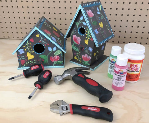 Tiny But Mighty Stubby Tool Set For Small Hands And Tight Spaces Includes Mini Hammer, Mini Screwdriver Set And Mini Wrench In Bright Red on table with painted birdhouses and paint bottles in background