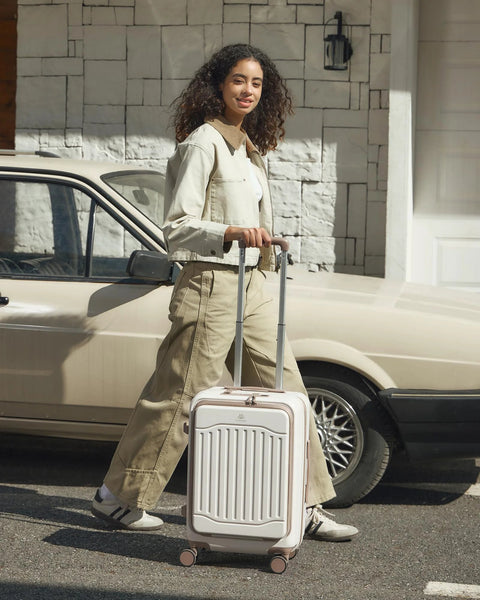 Woman with Expandable 22x14x9 Carry On Luggage With USB Charging Port Front Pocket And TSA Lock PC Hardside Spinner Wheels