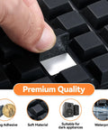 Hand applying Top Tier Self Adhesive Rubber Feet For Electronics And Gear 16 Pack Black Anti Slip Pads on a surface.