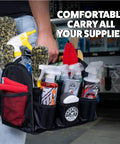 Person holding Grab And Go Quick Load Collapsible Car Detailing Caddy Organizer filled with towels and bottles.