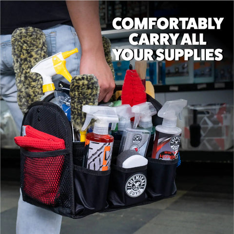 Person holding Grab And Go Quick Load Collapsible Car Detailing Caddy Organizer filled with towels and bottles.