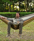 Man relaxing in a Super Comfy Double Hammock With Mosquito Net For Outdoors Portable Lightweight Nylon Parachute Hammock.