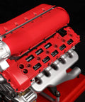 V12 Engine Model Kit With Over Eight Hundred Metal Parts Motorized Four Stroke Engine Electric Drive DIY STEM Build Realistic Anodized Aluminum And Stainless Steel Components Hands On Educational Gift For Adults And Car Enthusiasts red engine model close-up