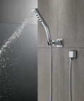 H2Okinetic Wall Mount Hand Shower With Massaging Spray And Pause Feature, Rubber Touch-Clean Spray Holes shown on gray tile wall