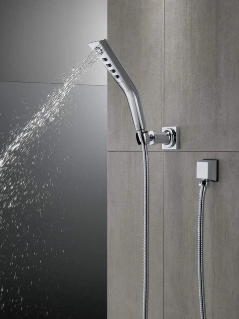 H2Okinetic Wall Mount Hand Shower With Massaging Spray And Pause Feature, Rubber Touch-Clean Spray Holes shown on gray tile wall