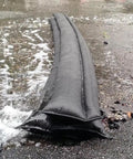 Water Activated Flood Barrier 17 Feet One Pack That Swells Up To Three Point Five Inches In Minutes installed on wet pavement