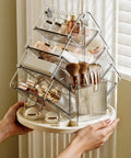 Sturdy Clear Swivel Makeup Organizer, 360 Slick Spin Lazy Susan Tray For Vanities displaying makeup and brushes in clear plastic compartments.