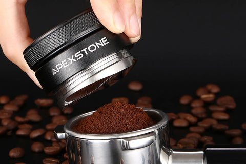 Close-up of Apexstone 53mm coffee distributor above a stainless steel portafilter filled with ground coffee
