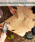 Children using a magnifying glass to explore a treasure map with a compass, part of an Outdoor Adventure Kit For Kids With Walkie Talkies, Binoculars, And Magnifying Glass, Kid Friendly Explorer Gear For Camping, Hiking, And Backyard Fun, Creative And Educational Play Set For Boys And Girls.