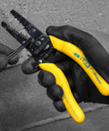 Reflex Super NM Cable Stripper For 12/2 And 14/2 Solid NM Wire, gloved hand using dual stripper heads tool