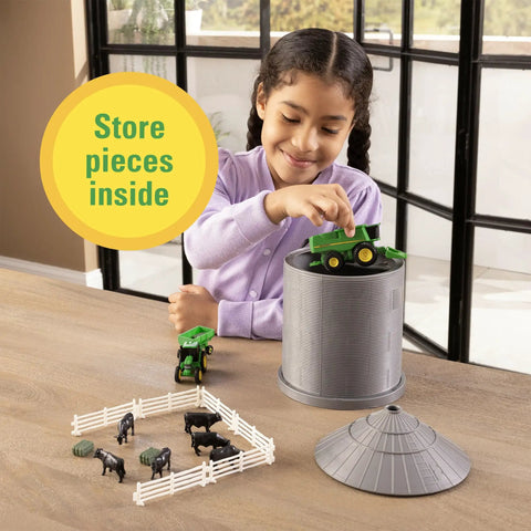 Child playing with 1 64 Scale Farm Playset With Grain Bin Includes Tractor Toys Skid Steer Farm Animal Figures And Fencing