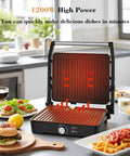 Versatile Contact Grill And Panini Press With 180 Degree Floating Hinge Plates For Steaks, Sausages, Quesadillas on a kitchen counter, showing heating elements.