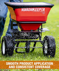 Grounds Keeper All Season Walk Behind Spreader For Seed Fertilizer And Winter Salt With 100 lb Hopper Capacity in use on lawn