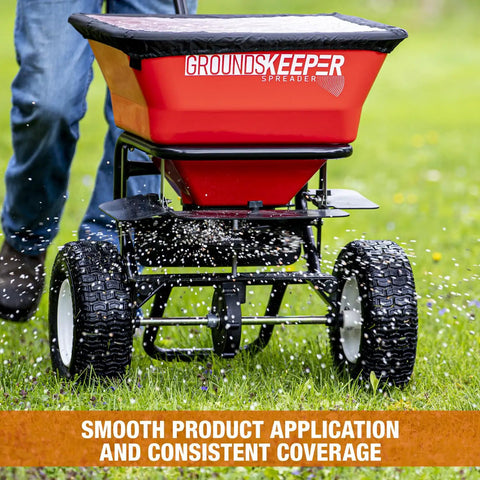 Grounds Keeper All Season Walk Behind Spreader For Seed Fertilizer And Winter Salt With 100 lb Hopper Capacity in use on lawn