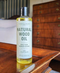 Natural Wood Conditioning Oil With Coconut Oil For Natural Furniture Care Orange Scent 8 Oz bottle on wooden table.