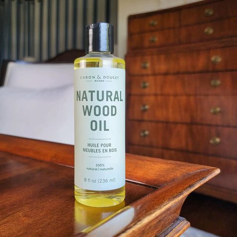 Natural Wood Conditioning Oil With Coconut Oil For Natural Furniture Care Orange Scent 8 Oz bottle on wooden table.