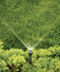 No Fuss Shrub Head Sprinkler With Quarter Pattern Spray Nozzle For Outdoor Gardens And Landscaping, watering shrubs in a garden.