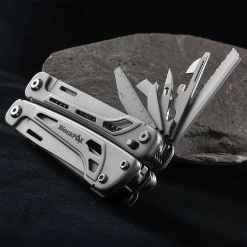 Fortitude BF 206 17 In 1 Stainless Steel EDC Multi Tool Pocket Knife With nylon sheath, tools open on rocky surface