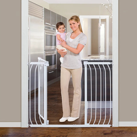 Woman holding child behind Multi-Use Extra Tall Walk Through Baby Gate In Metal White Finish, 36 Inch Tall, Fits Openings From 29 To 48 Inches Wide, Perfect Baby And Pet Gate For Doorways And Stairways, Easy Install With Quick Mount Kit