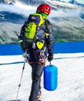 Hiker in snowy mountains carrying Portable Waterproof Sleeping Bag For Adults And Kids, 4 Seasons Cold Weather Or Warm, Ideal For Backpacking.