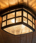 Stonington Outdoor Flush Mount Ceiling Light With 12 Inch Two Light Palladian Bronze Finish, Vintage Close To Ceiling Exterior Fixture For Patio Porch Or Balcony, Water Glass Illumination And Mission Style Old School Charm installed on wooden ceiling.