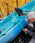 Person using Two Pack Truck Bed Anchor Kit For Tailgate with rugged polyester webbing to secure a blue kayak in a pickup truck bed.