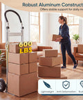 Heavy Duty Folding Hand Truck Workhorse With Aluminum Dolly Cart moving boxes in a living room, ergonomic grip, 600 lbs capacity