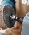 Four Prong Spring Loaded Spur Drive Center 2MT for wood lathe in action, gripping a wood block with 1 inch grip and sharp spurs.
