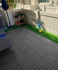 Interlocking Plastic Deck Tiles 36 Sq Ft Pack 36 12 by 12 Inches Waterproof Outdoor Flooring for Porch Poolside Balcony Backyard Pathway All Weather Charcoal Gray DIY Friendly Easy Install Durable Lightweight in a backyard setting