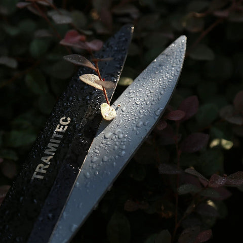 Close-up of Ergonomic 21 Inch Garden Hedge Shears Pro Grade with high carbon steel wet blades cutting a leaf.